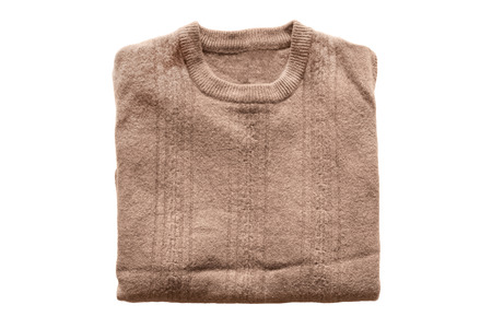 Folded brown wool sweater on white backgroundの写真素材