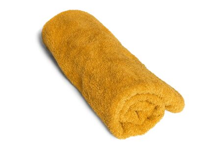 Yellow terry towel folded on white backgroundの写真素材