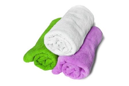 Colorful bath towels folded on white backgroundの写真素材