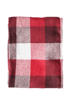 Red wool plaid folded on white backgroundの写真素材