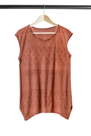 Terracotta top on wooden clothes rack isolated over whiteの写真素材
