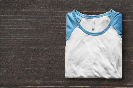 Folded sport shirt on dark wooden backgroundの写真素材