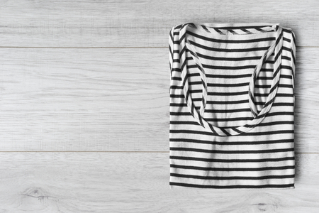 Black jeans folded on white wooden backgroundの写真素材