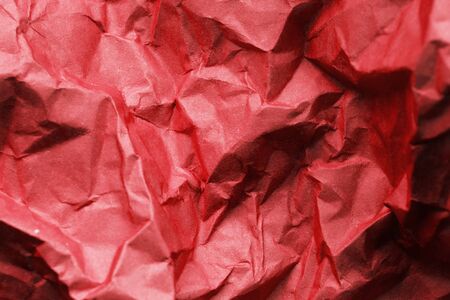 Red crumpled wrapping paper as a backgroundの写真素材