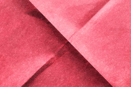 Blank pink folded paper as a backgroundの写真素材