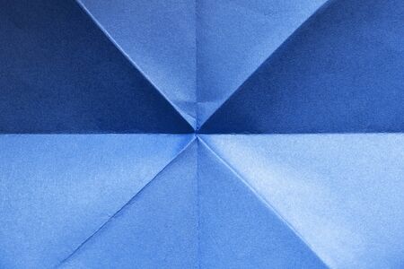 Folded blue blank paper as a backgroundの写真素材