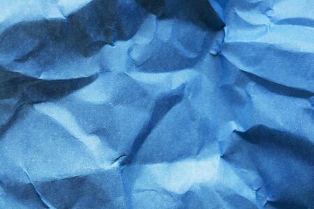 Crumpled blue blank paper as a backgroundの写真素材