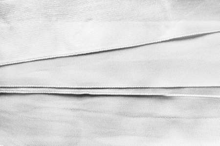White blank satin ribbons as a backgroundの写真素材