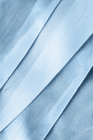 Blue satin ribbons closeup as a backgroundの写真素材
