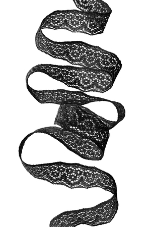 Black lacy ribbon on white backgroundの写真素材