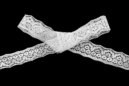 White tied bow lace isolated over blackの写真素材