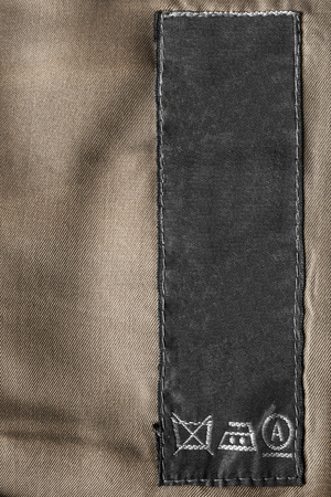 Washing instructions clothes label on brown clothの写真素材