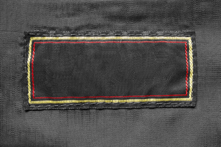 Blank black clothes label with colorful frame as a backgroundの写真素材