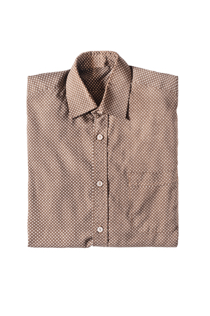 Folded brown silk polka dots shirt isolated over whiteの写真素材