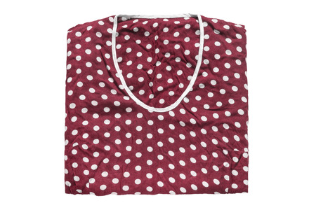 Polka dots red shirt folded on white backgroundの写真素材