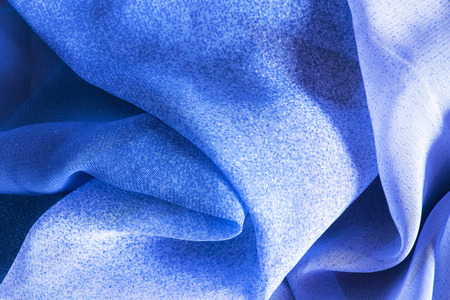 Crumpled blue silk closeup as a backgroundの写真素材