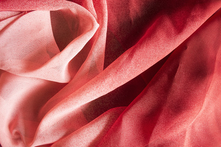Abstract red draped silk closeup as a backgroundの写真素材