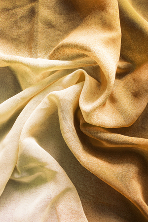 Draped yellow chiffon closeup as a backgroundの写真素材