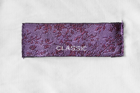 Clothes label lettered classic on white cotton as a backgroundの写真素材