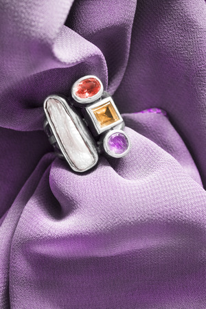 Vintage nacre and gems ring on purple draped silkの写真素材
