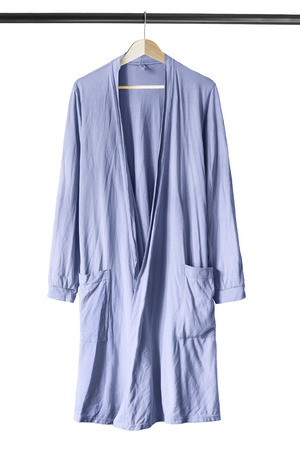 Blue cotton bathrobe on wooden clothes rack isolated over whiteの写真素材