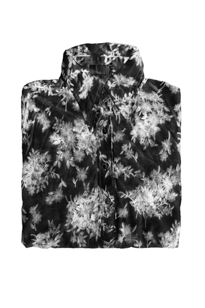 Folded silk black and white blouse isolated over whiteの写真素材