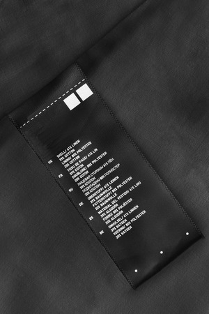 Fabric composition label on black linen as a backgroundの写真素材