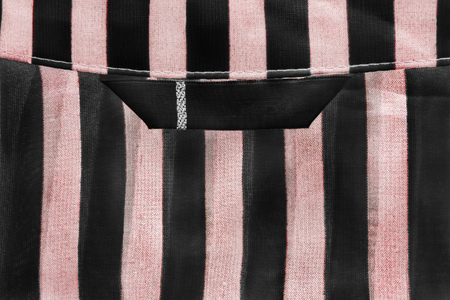 Blank clothes label on striped pink and black clothの写真素材