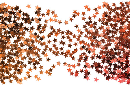 Abstract golden sparkling stars on white as a backgroundの写真素材