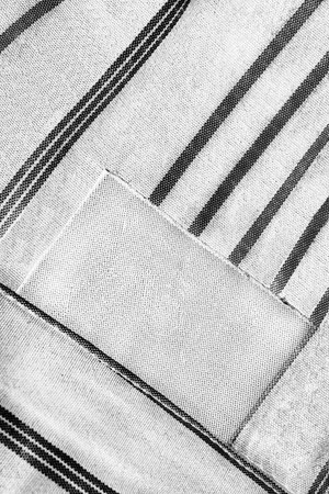 Blank clothes label on striped black and white cloth
