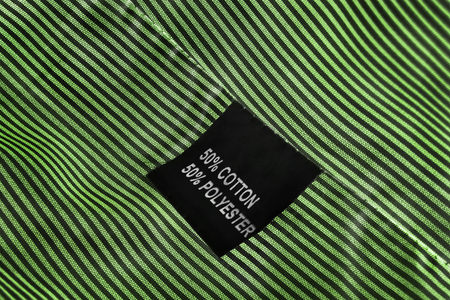 Fabric composition label on striped green cloth as a backgroundの写真素材