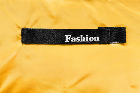 Clothes label lettered fashion on yellow clothの写真素材