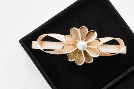 Golden flower shaped barrette in black jewel box closeupの写真素材