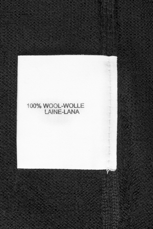 Fabric composition label on black wool closeupの写真素材