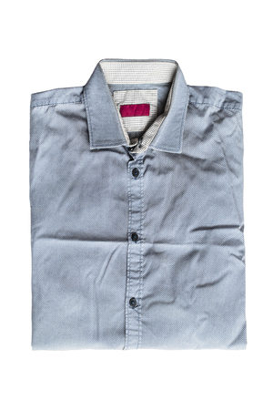 Folded blue shirt isolated over whiteの写真素材