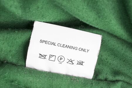Washing instructions label on green cloth closeupの写真素材