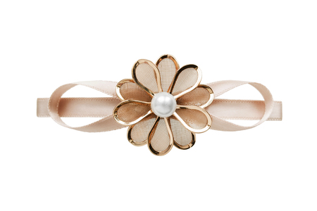 Golden flower shaped barrette isolated over whiteの写真素材