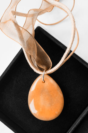 Amber pendant in black jewel box closeupの写真素材