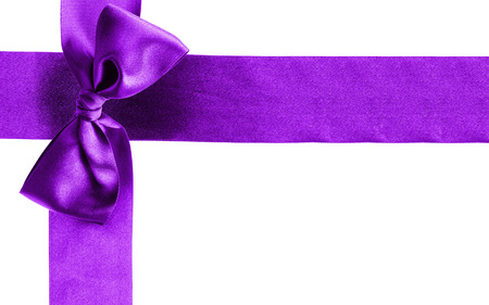 Decorative purple ribbon with tied bow isolated over whiteの写真素材