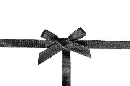 Black satin tied bow ribbon on white backgroundの写真素材