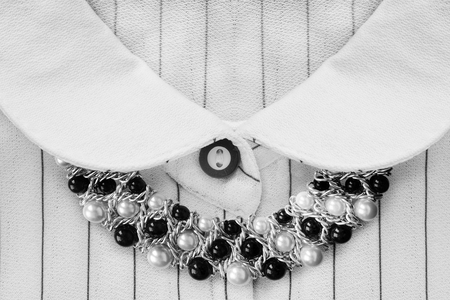 Black and white pearl necklace over striped white blouse closeupの写真素材