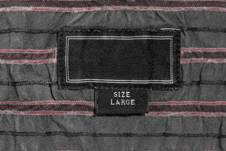 Black clothes label lettered large size closeup as a background