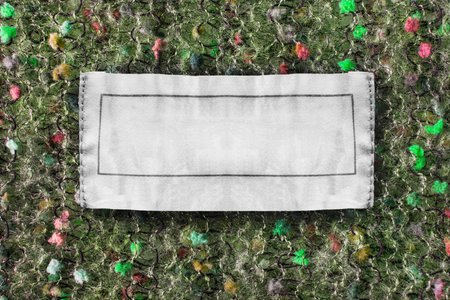 White blank clothes label on colorful knitted background