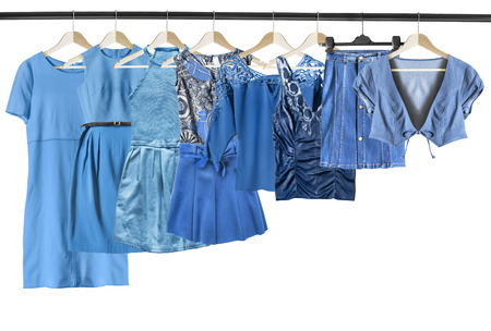 Set of blue woman clothes on clothes racks on white backgroundの写真素材