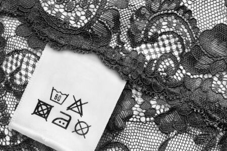 Washing instructions clothes label on black lace closeupの写真素材