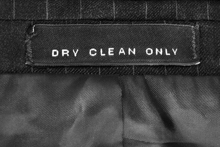 Washing instructions clothes label on black textile background