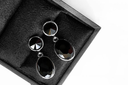Black onyx silver earrings in black jewel box closeupの写真素材