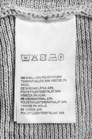 Fabric composition and washing instructions clothes label closeupの写真素材