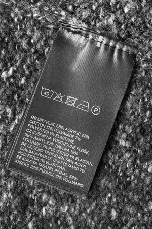 Fabric composition and washing instructions clothes label on textile background closeupの写真素材