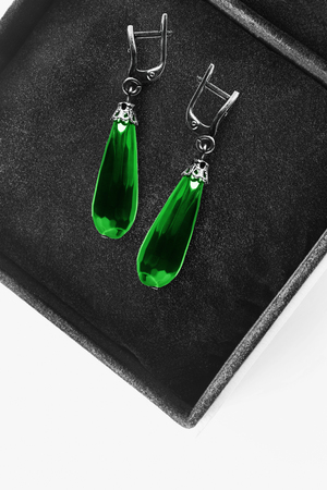 Emerald faceted drop shaped earrings in black jewel boxの写真素材